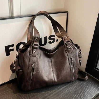 Stylish brown leather shoulder bag for women with dual handles and zippered pockets